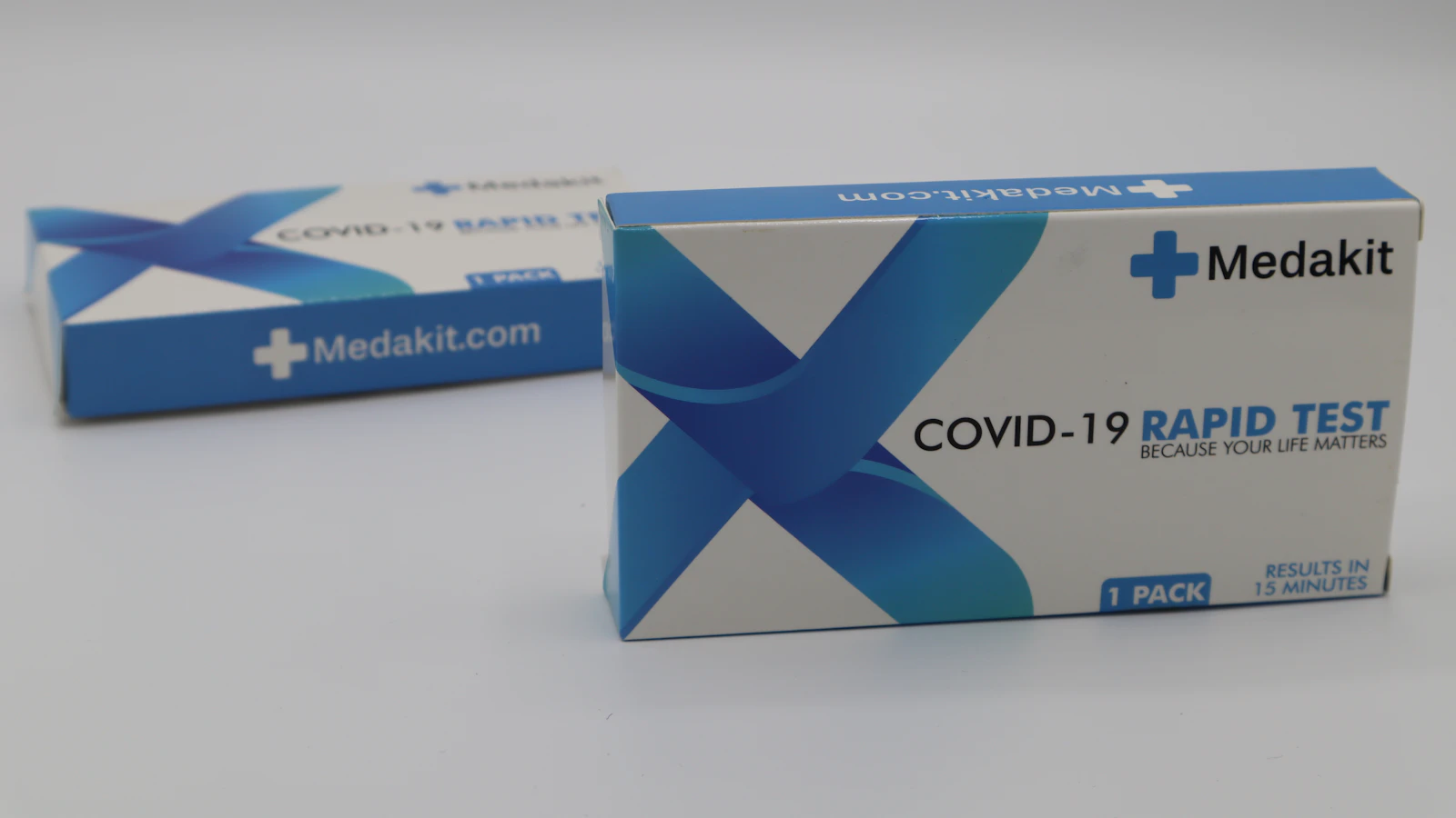 A blue and white test-kit box on a white table.