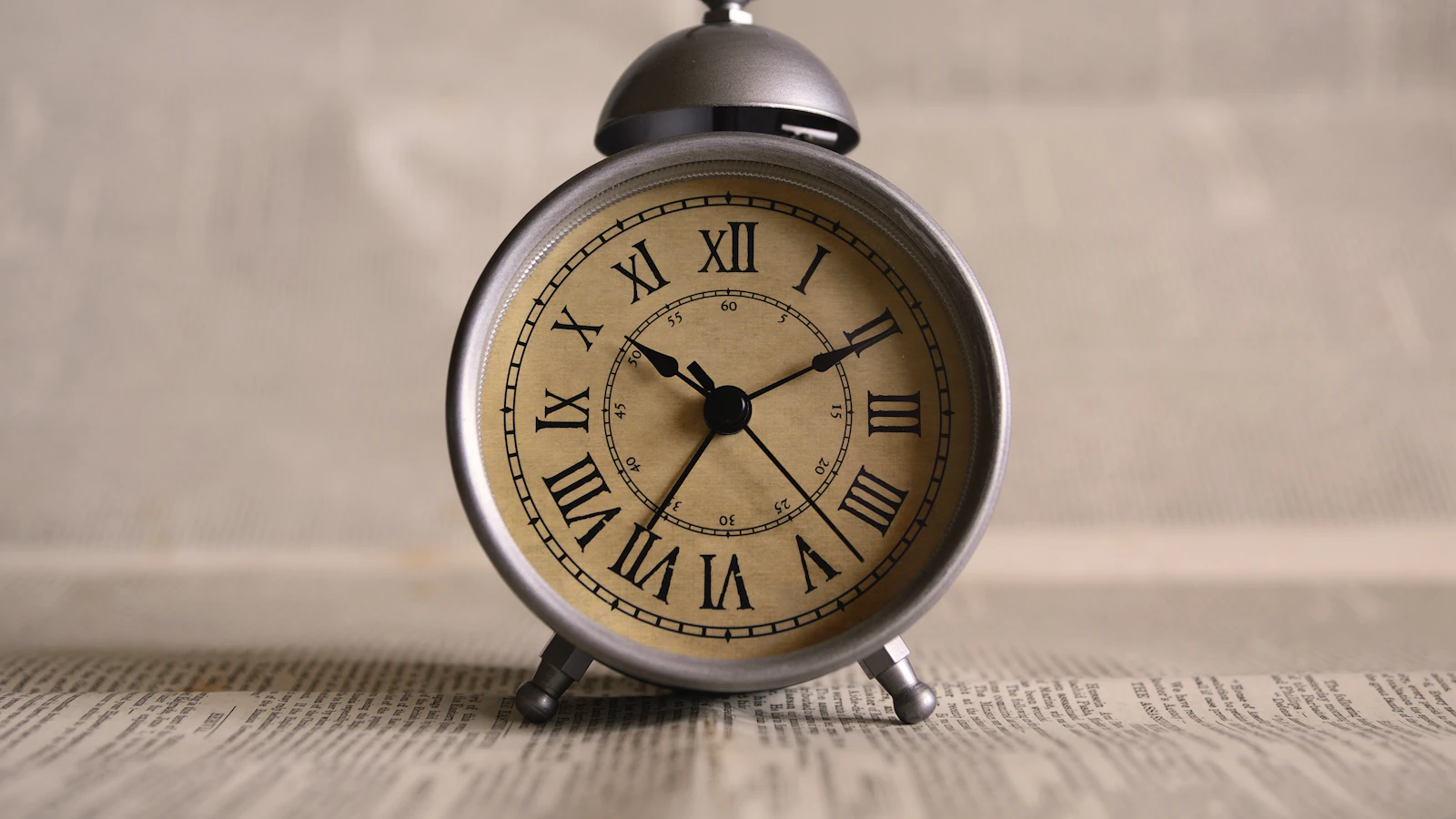 An alarm clock on a table emphasising the passing of time.